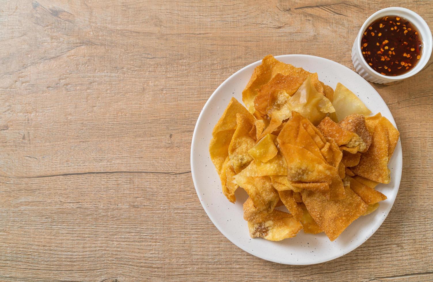 Deep-fried pork wonton with dipping sauce photo