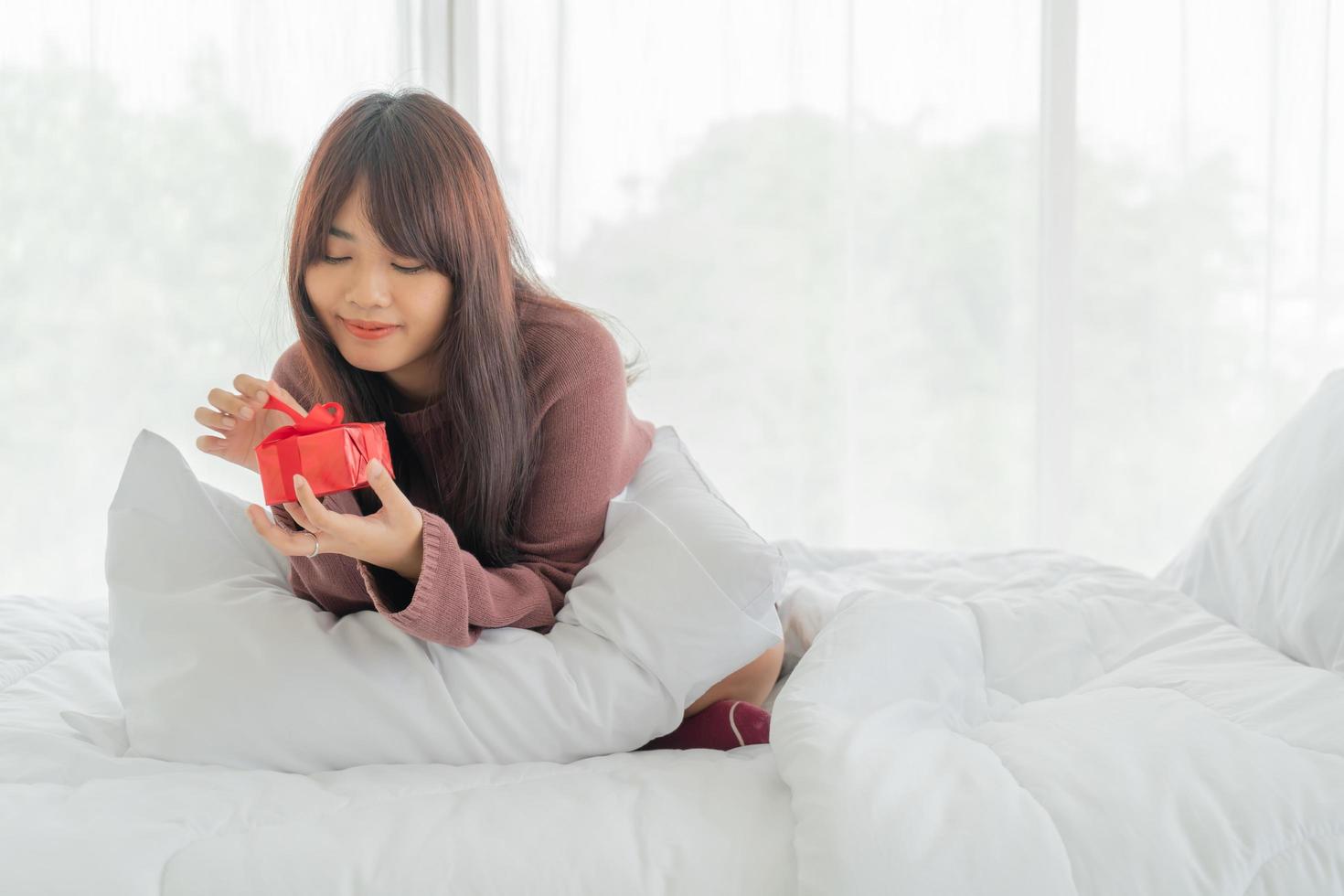 Asian woman happy to receive a gift box or present photo
