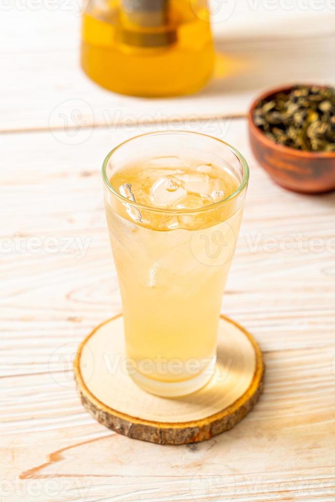 Iced jasmine tea on wood background photo