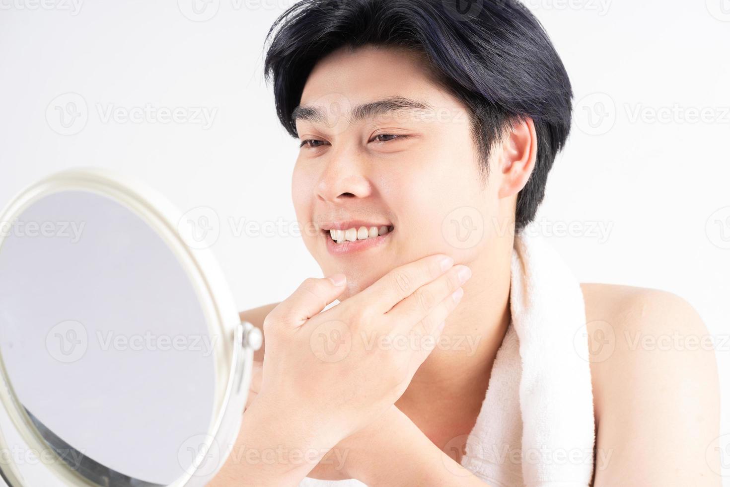 Young handsome Asian man with mirror photo