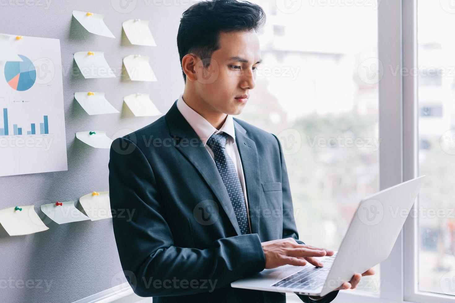 Asian businessman planning a business next to the plan board photo