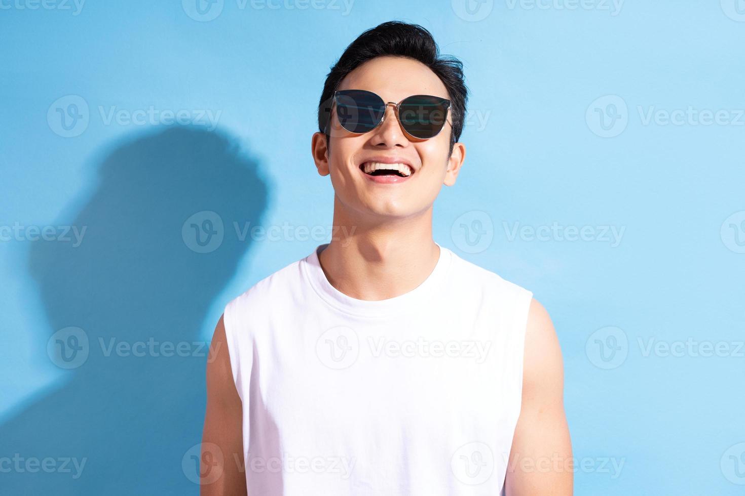 Portrait of handsome Asian man wearing sunglasses photo