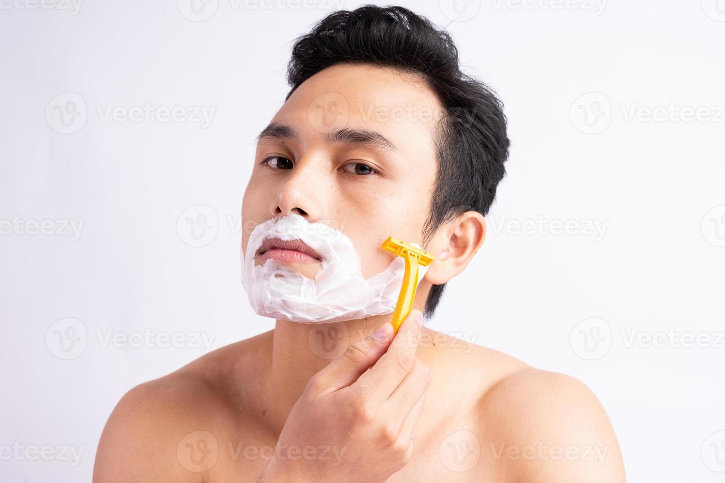 Portrait of Asian man shaving photo