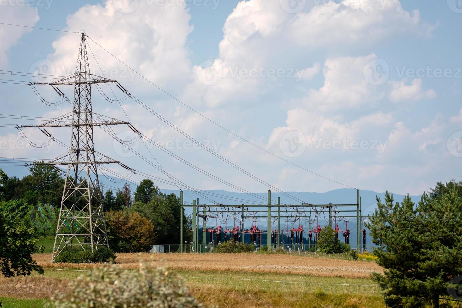 High-voltage substation on mountains and blue sky background. photo