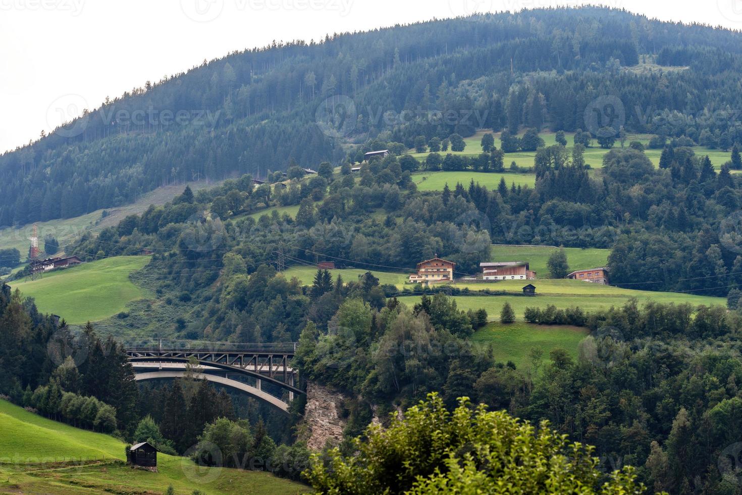 A picturesque Alpine landscape with an old railway bridge. Austria. photo