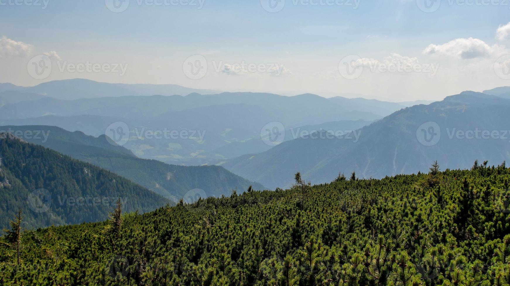 The Austrian Alpine mountain landscape on a hazy autumn day. photo