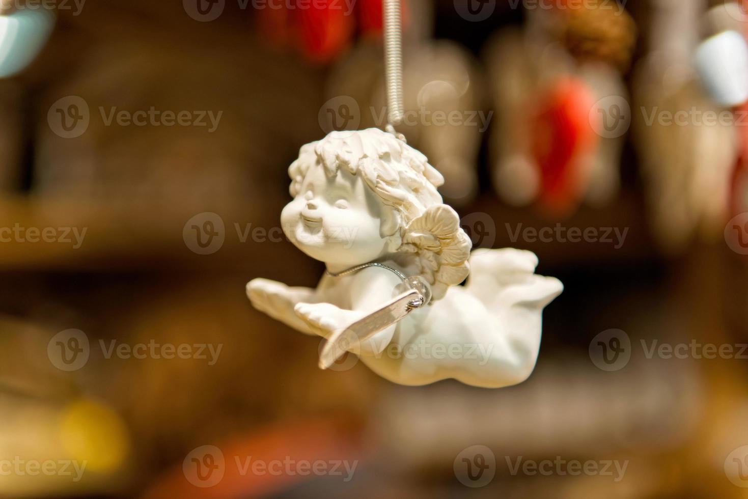 Porcelain angel figure on a blurry background photo