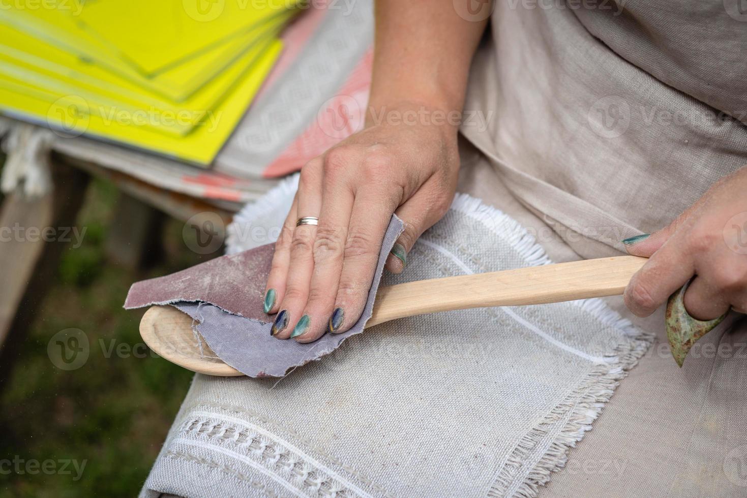 Woman making traditional handcraft wooden spoon photo