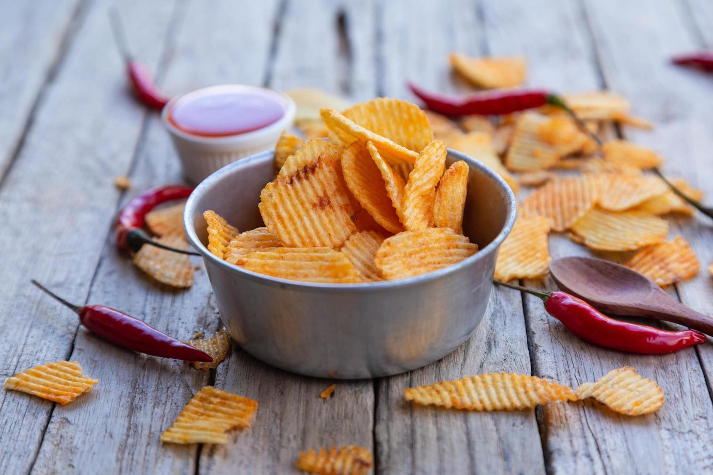 Homemade paprika potato chips and Chili sauce photo