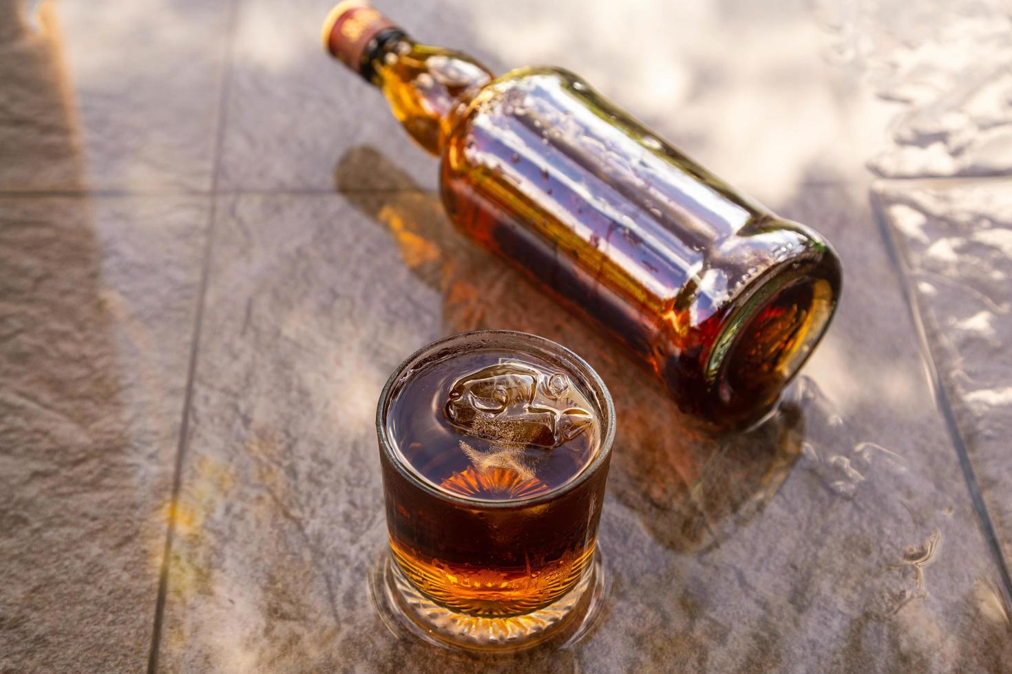 Liquor in glass and liquor bottles Alcoholic beverage concept photo