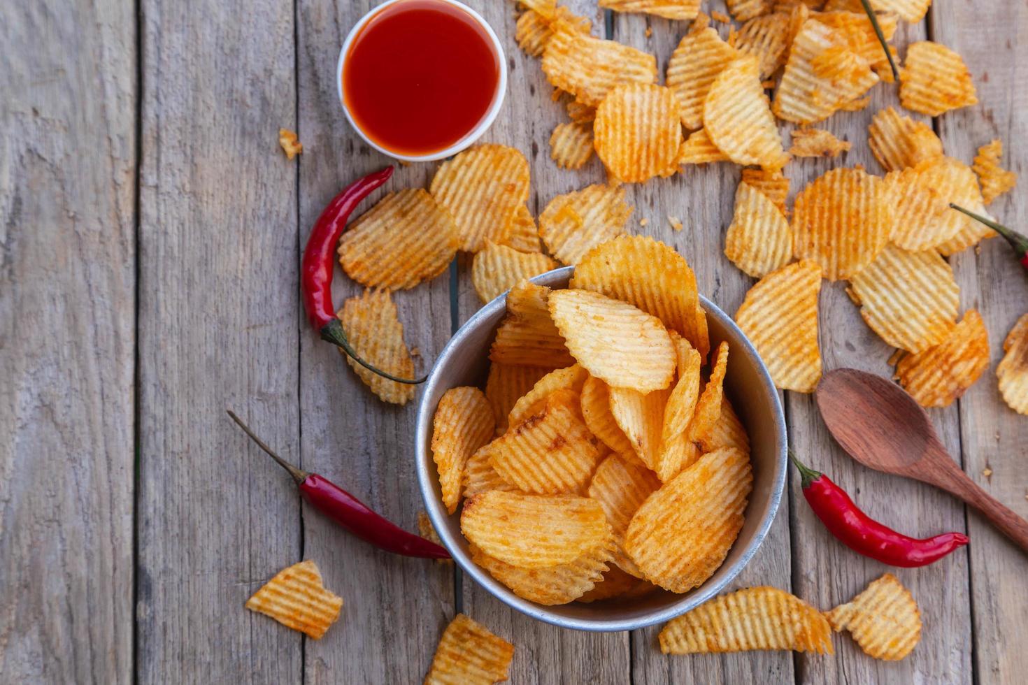 Homemade paprika potato chips and Chili sauce photo