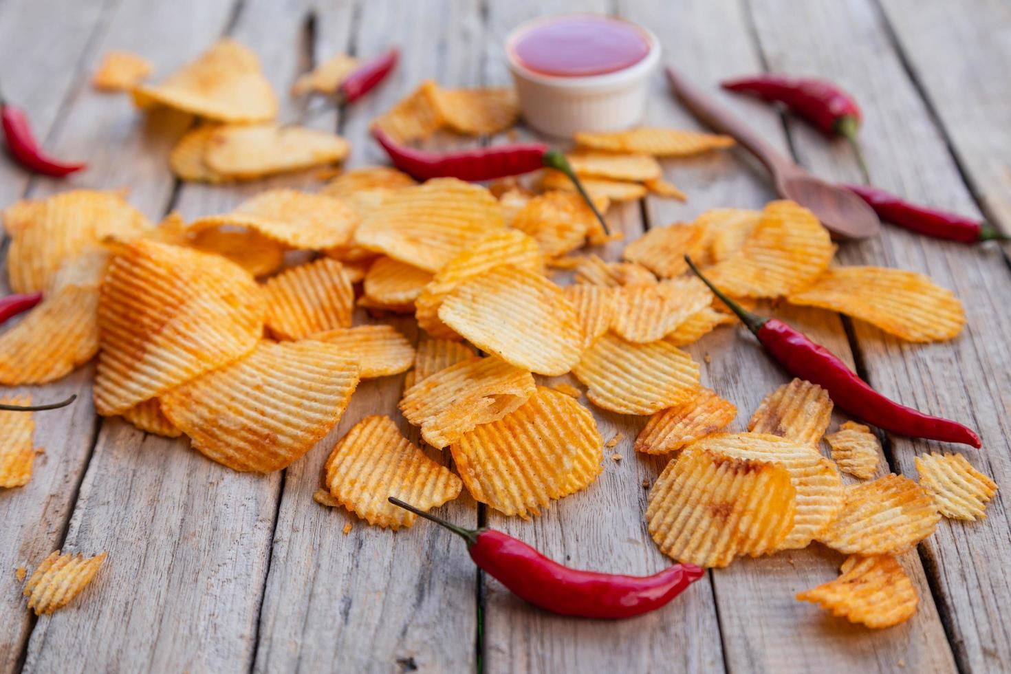 Homemade paprika potato chips and Chili sauce photo