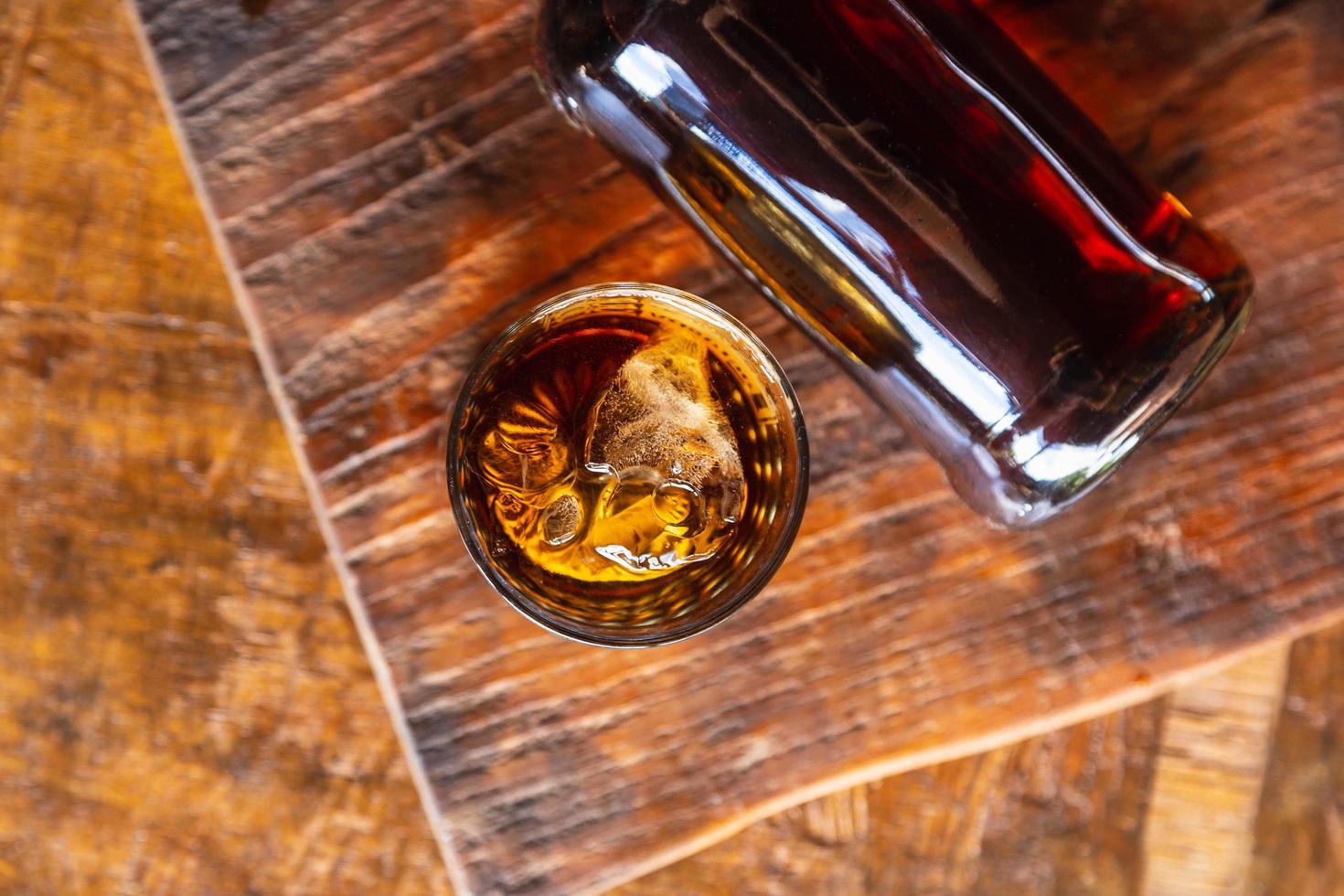 Liquor glass and decanter on wooden table photo