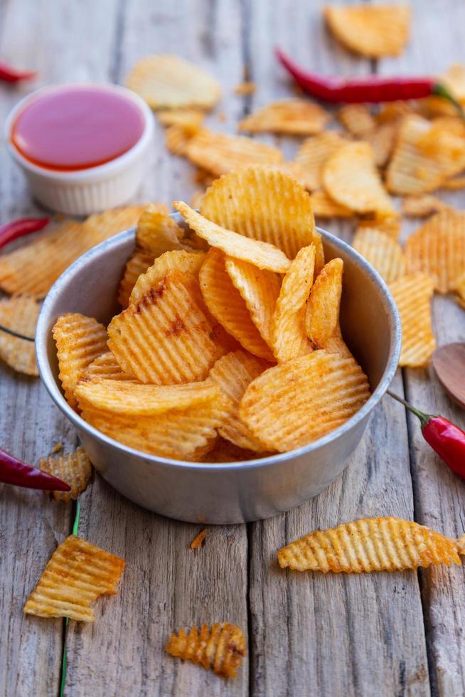 Homemade paprika potato chips and Chili sauce photo