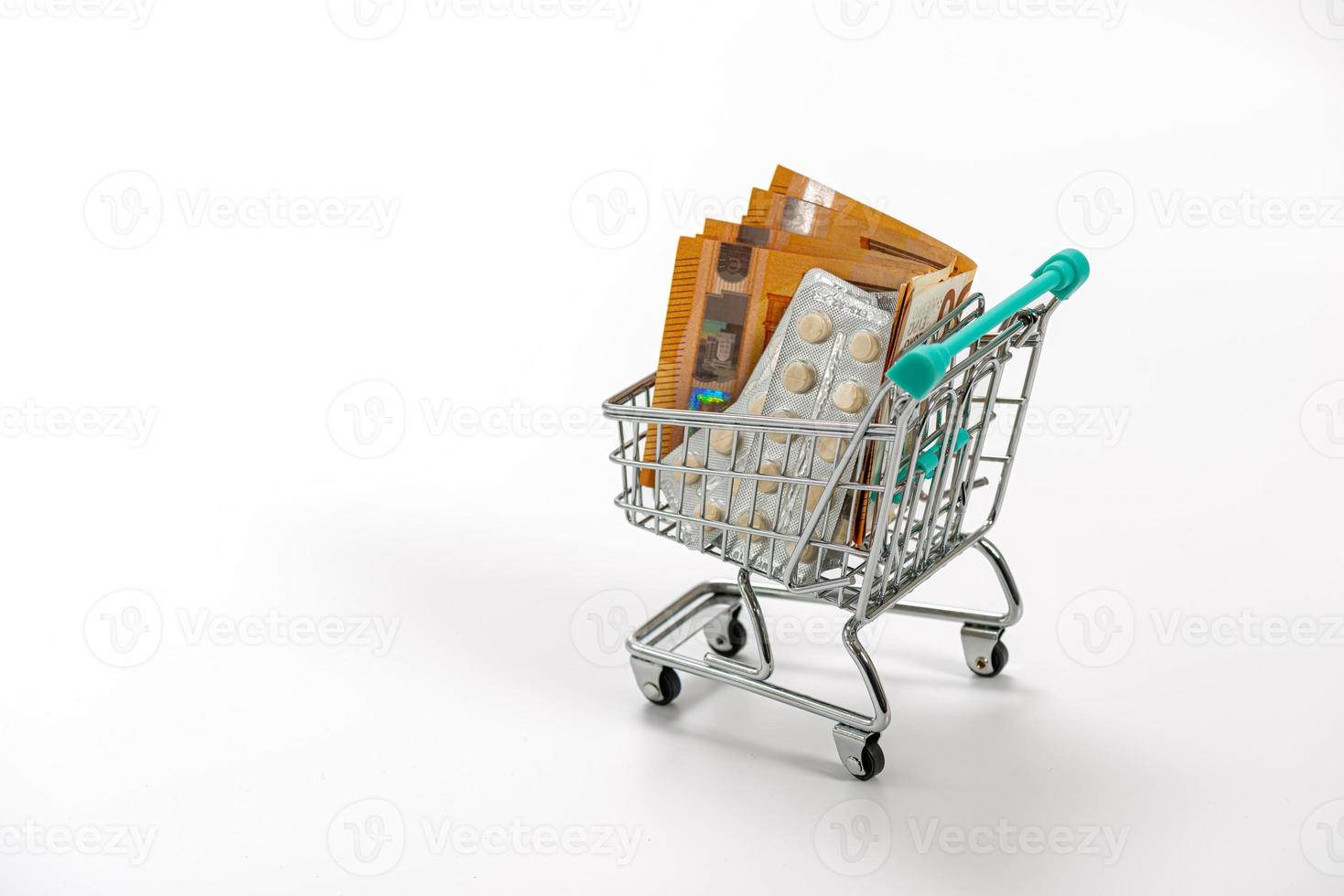 Shopping cart with pills and Euro banknotes photo