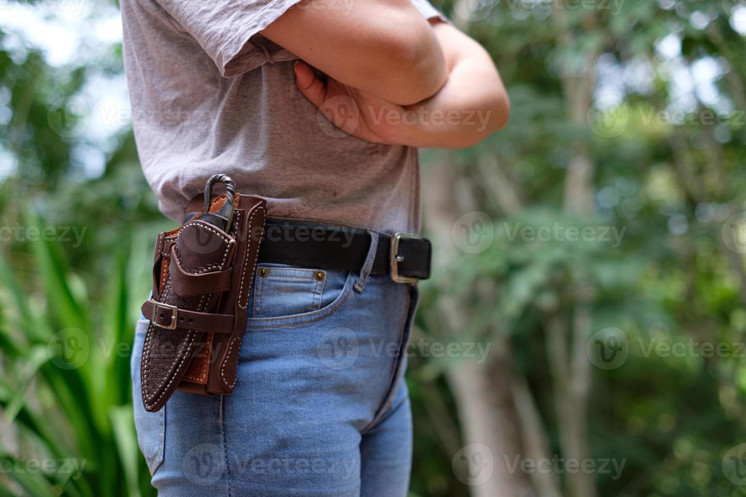 Knife in the case attached and hang on the belt of the woman photo