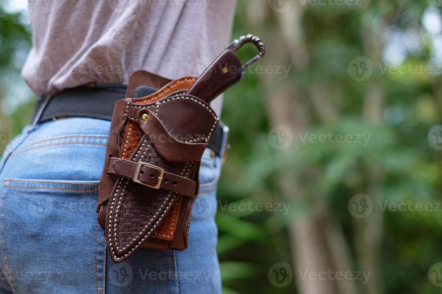 Knife in the case attached and hang on the belt of the woman photo