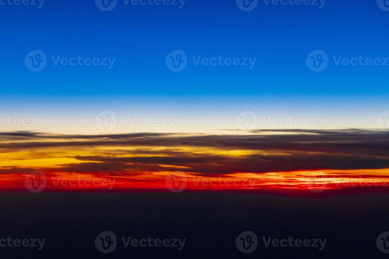 Flying over Europe to Mallorca at beautiful colorful sunset. photo