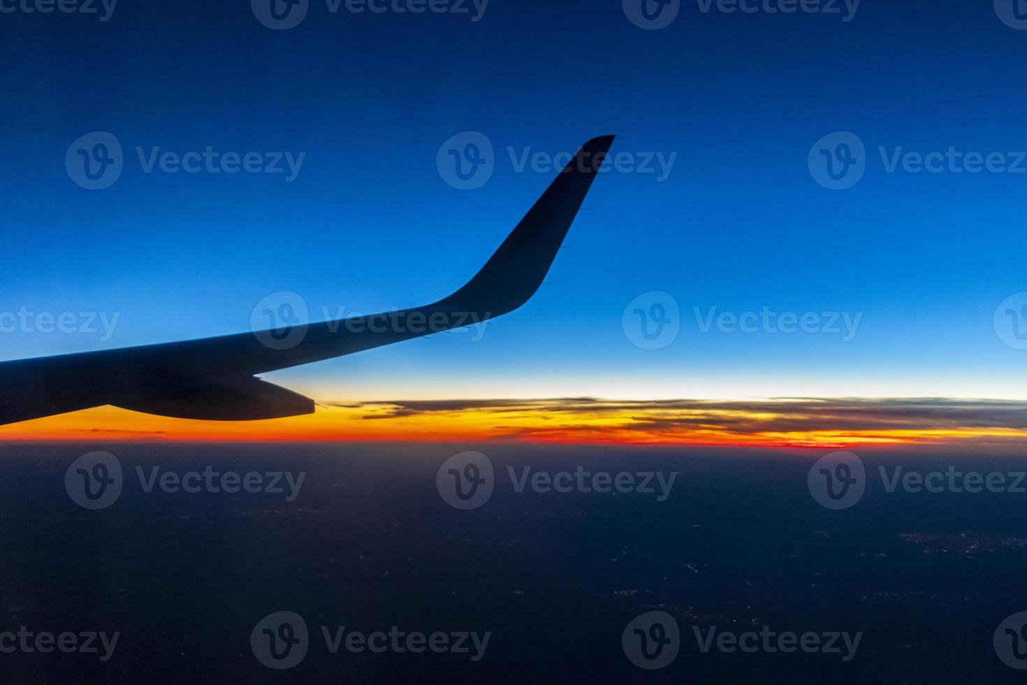 Flying over Europe to Mallorca at beautiful colorful sunset. photo