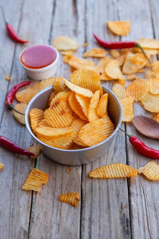 Homemade paprika potato chips and Chili sauce photo