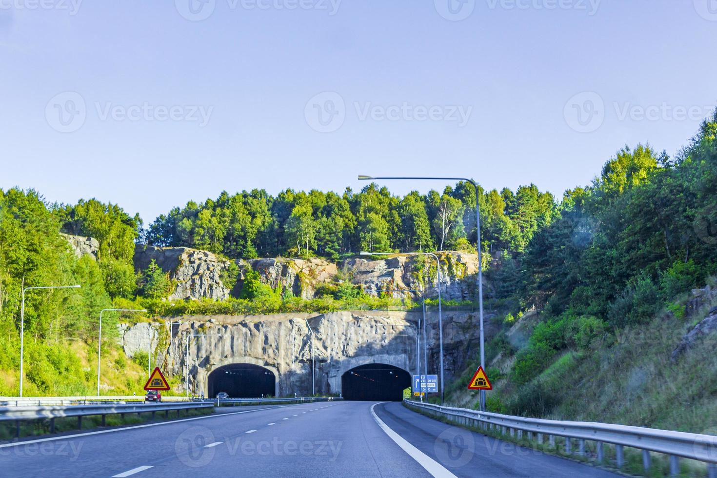 Driving through Sweden towards the tunnel in summer. photo