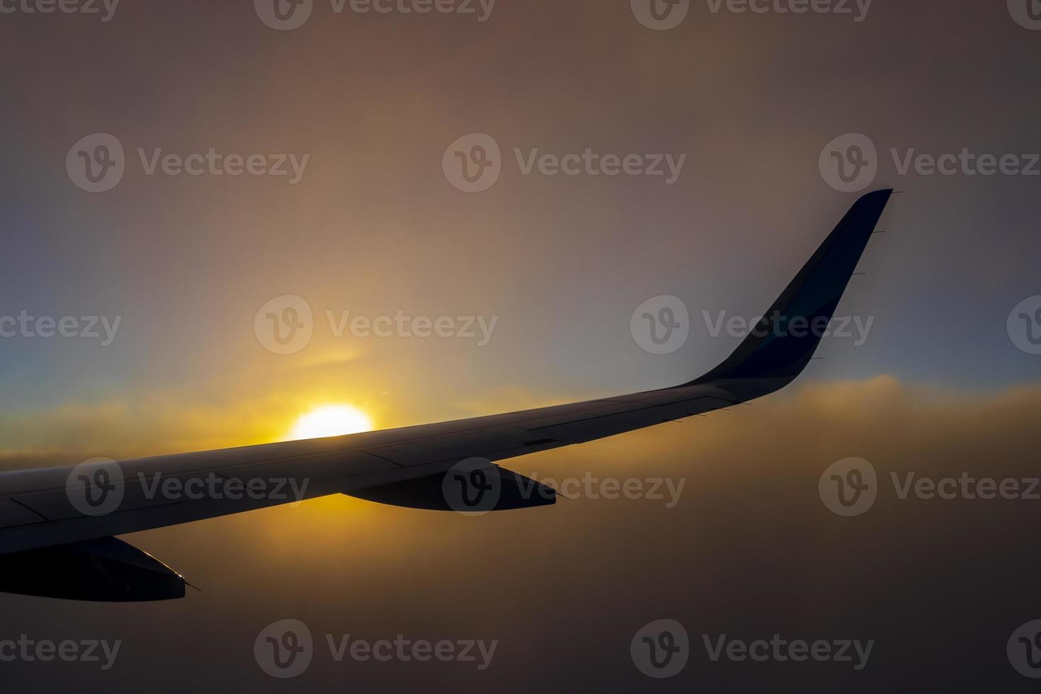 Flying over Europe to Mallorca at beautiful colorful sunset. photo