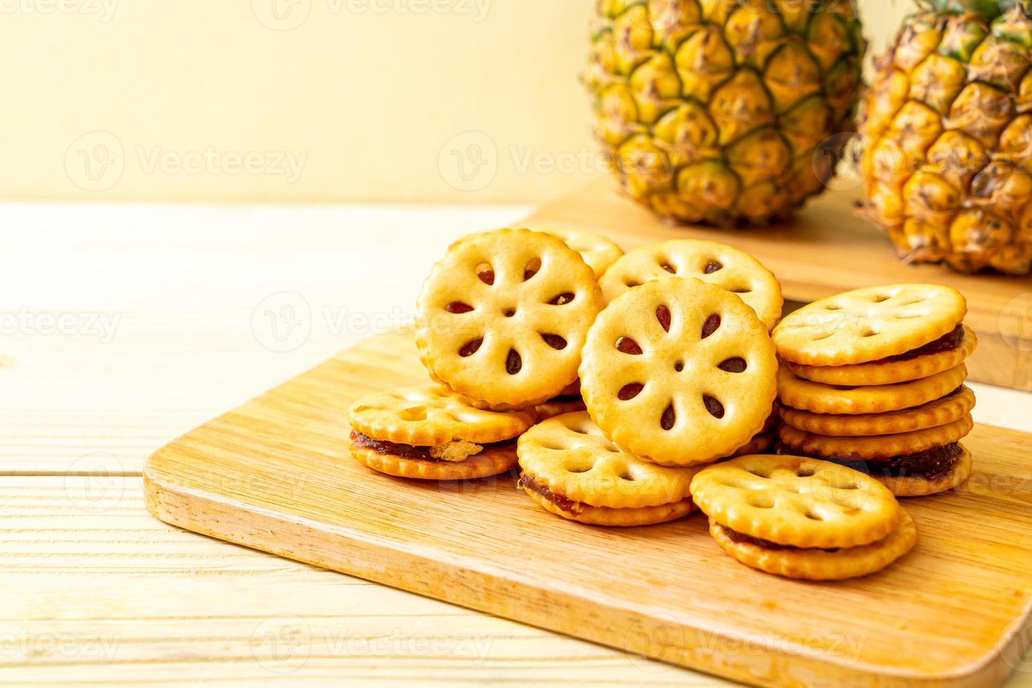 Biscuits with pineapple jam on wood background photo