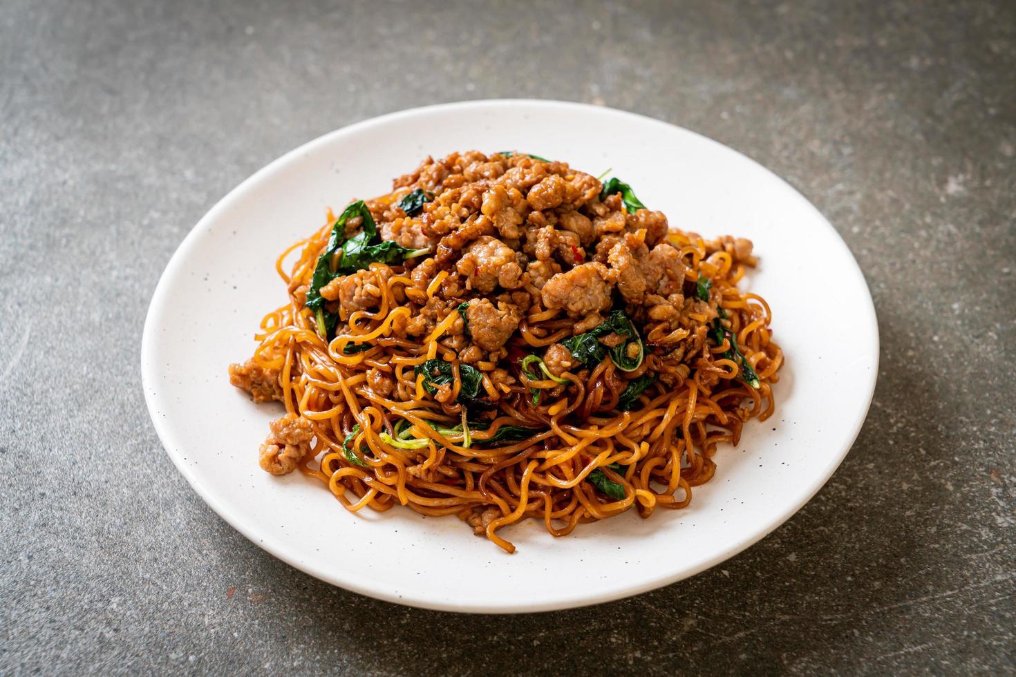 Stir-fried instant noodles with Thai basil and minced pork - Asian food style photo
