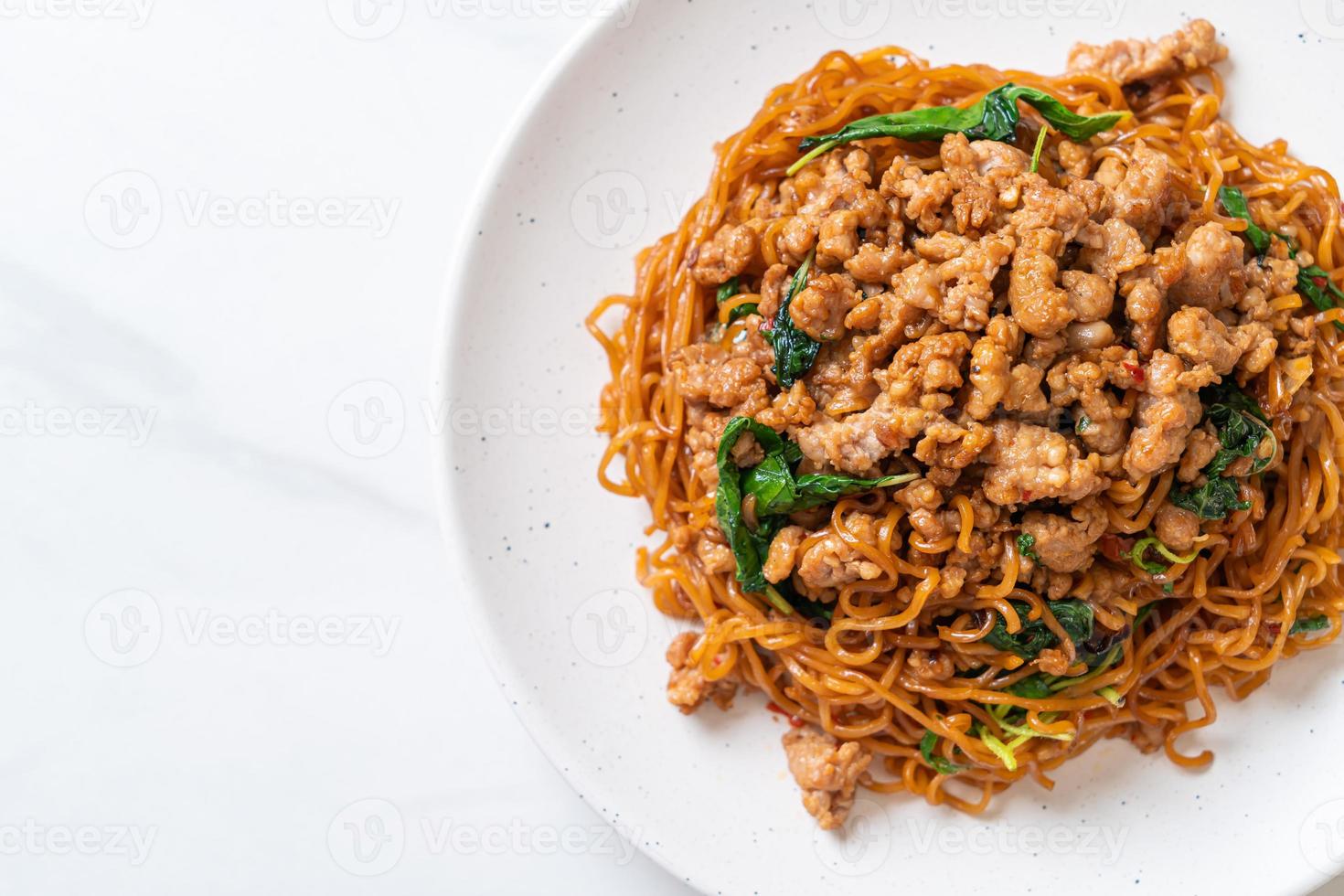 Stir-fried instant noodles with Thai basil and minced pork - Asian food style photo