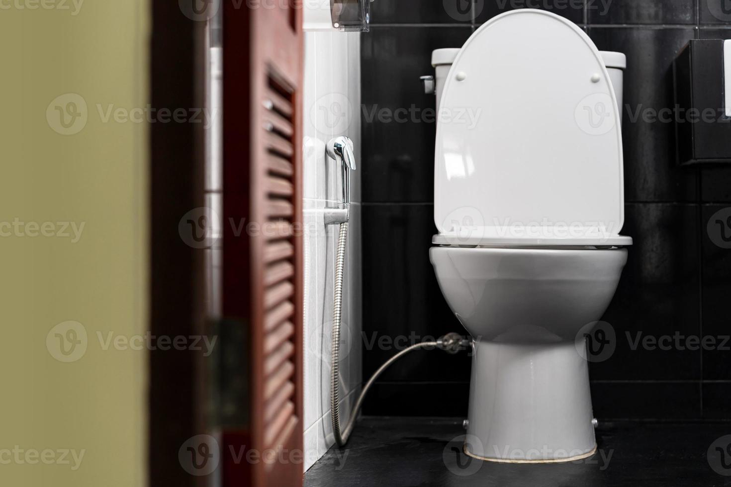 White toilet bowl in a bathroom of a private home photo