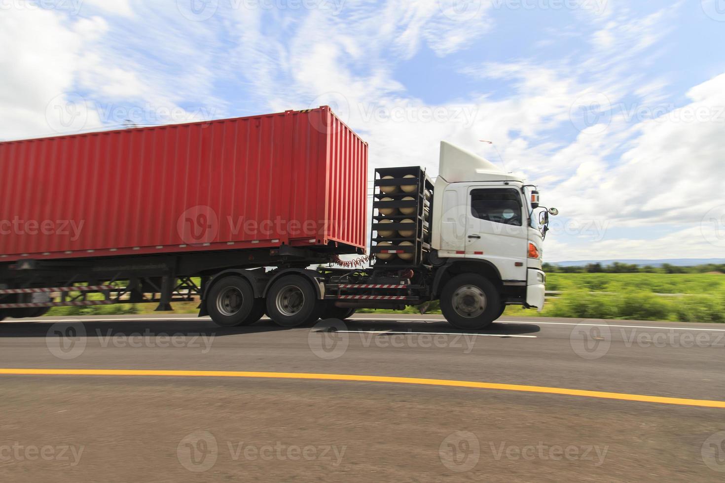 Red truck on the highway under the blue sky photo