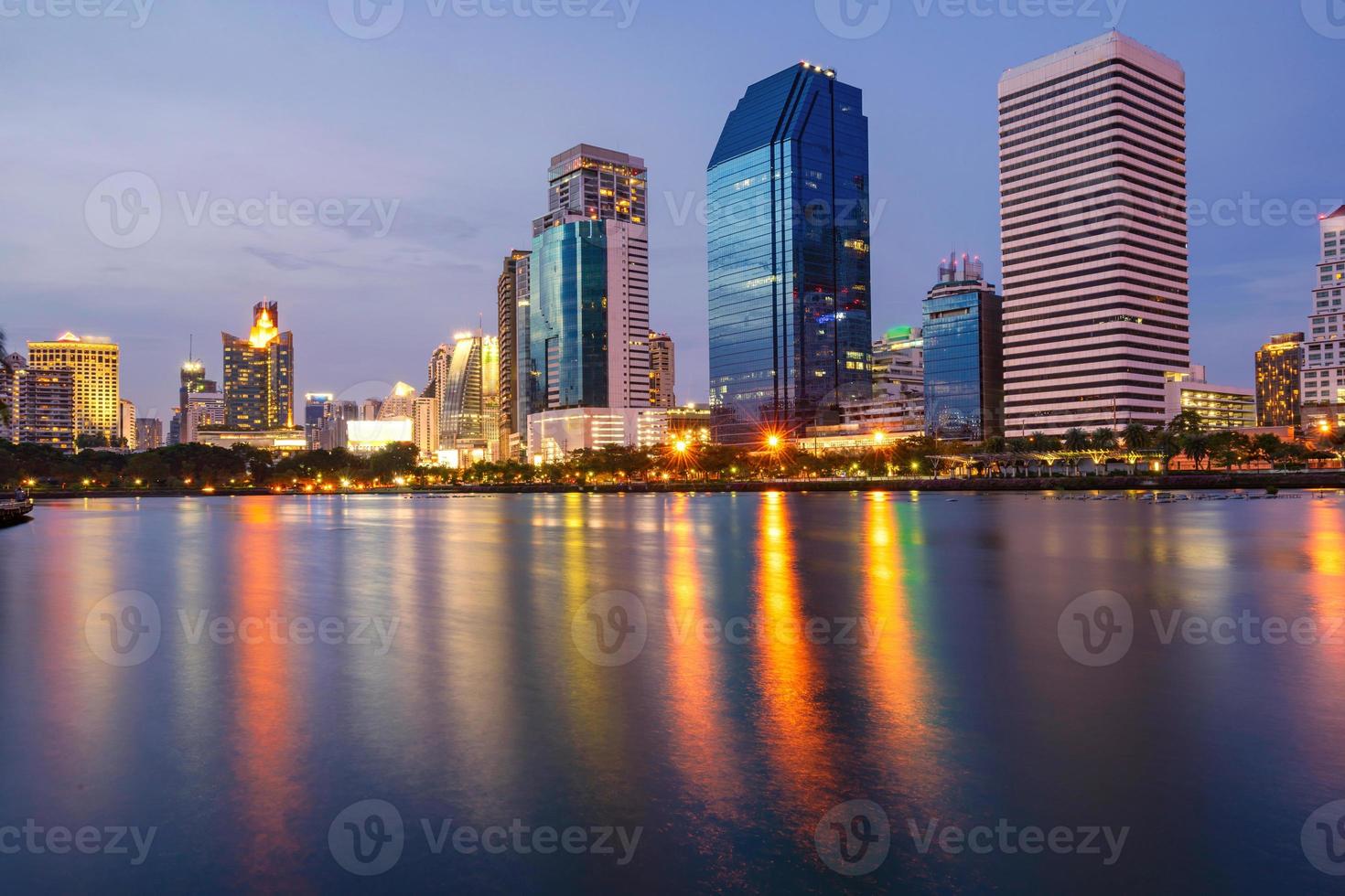 Bangkok city downtown at twilight with reflection of skyline, Benjakiti Park, Bangkok,Thailand photo