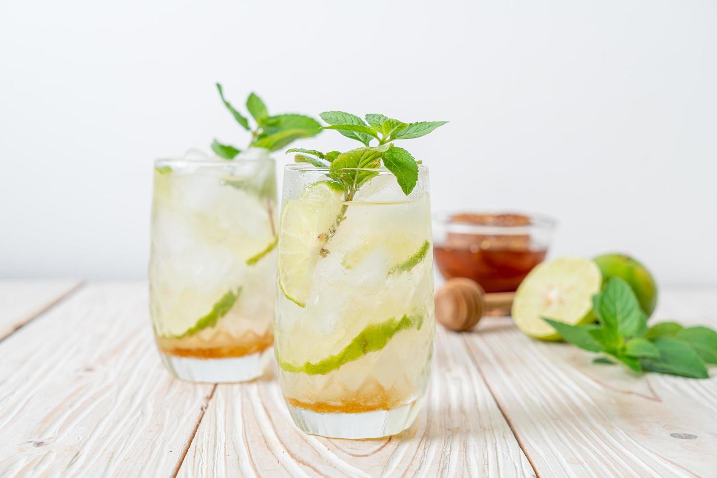 Iced honey and lime soda with mint - refreshing drink photo