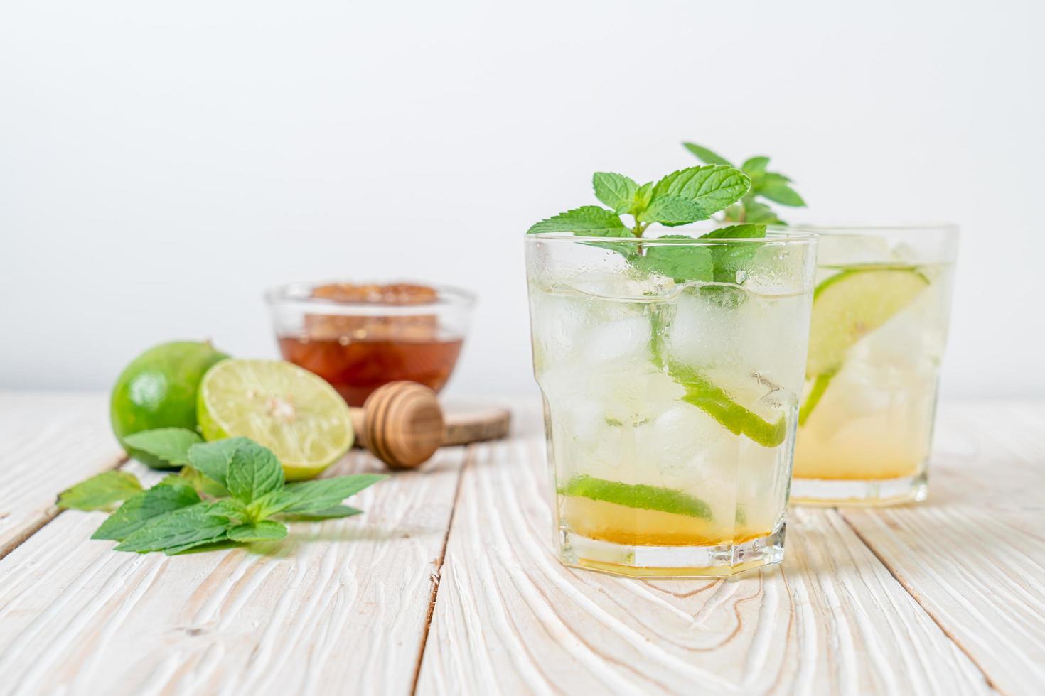 Iced honey and lime soda with mint - refreshing drink photo