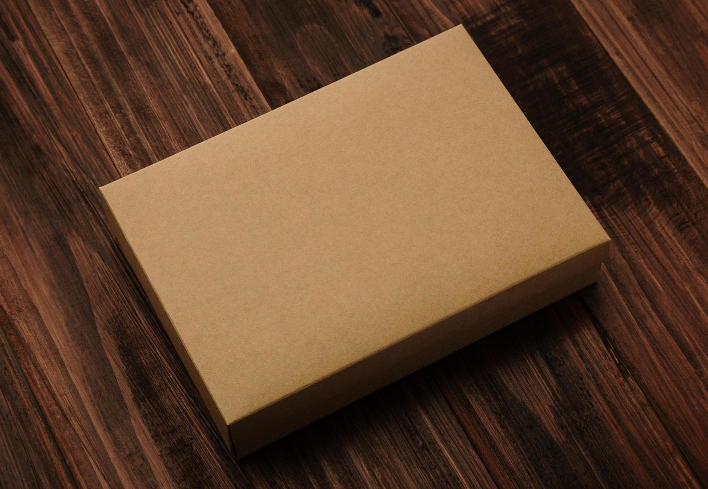 Cardboard box mockup on wooden background photo