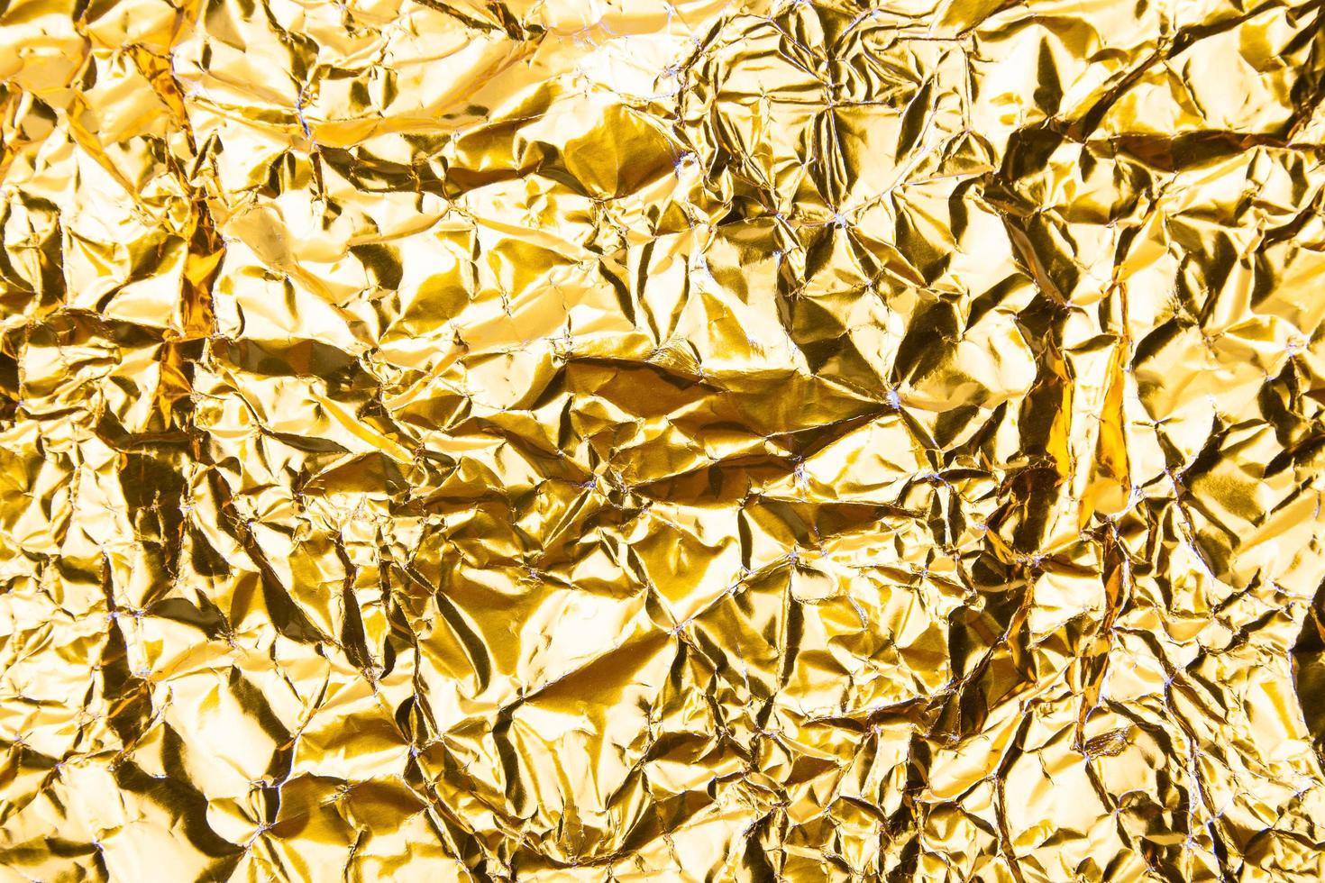 Golden cumpled paper texture background photo