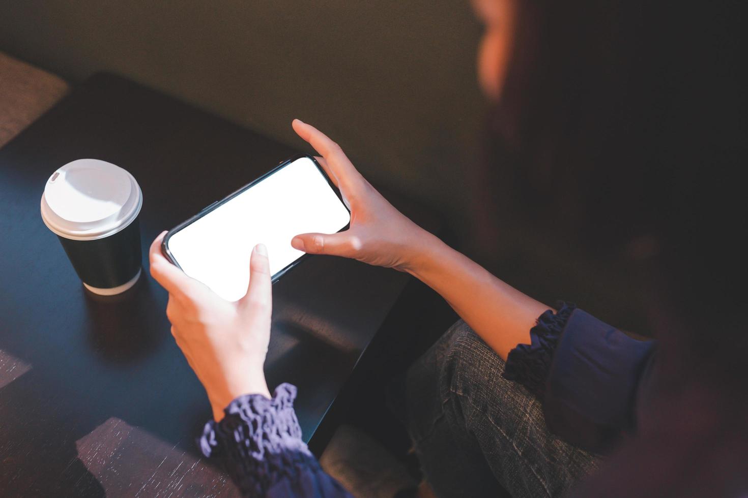 Woman using smartphone blank screen mockup photo