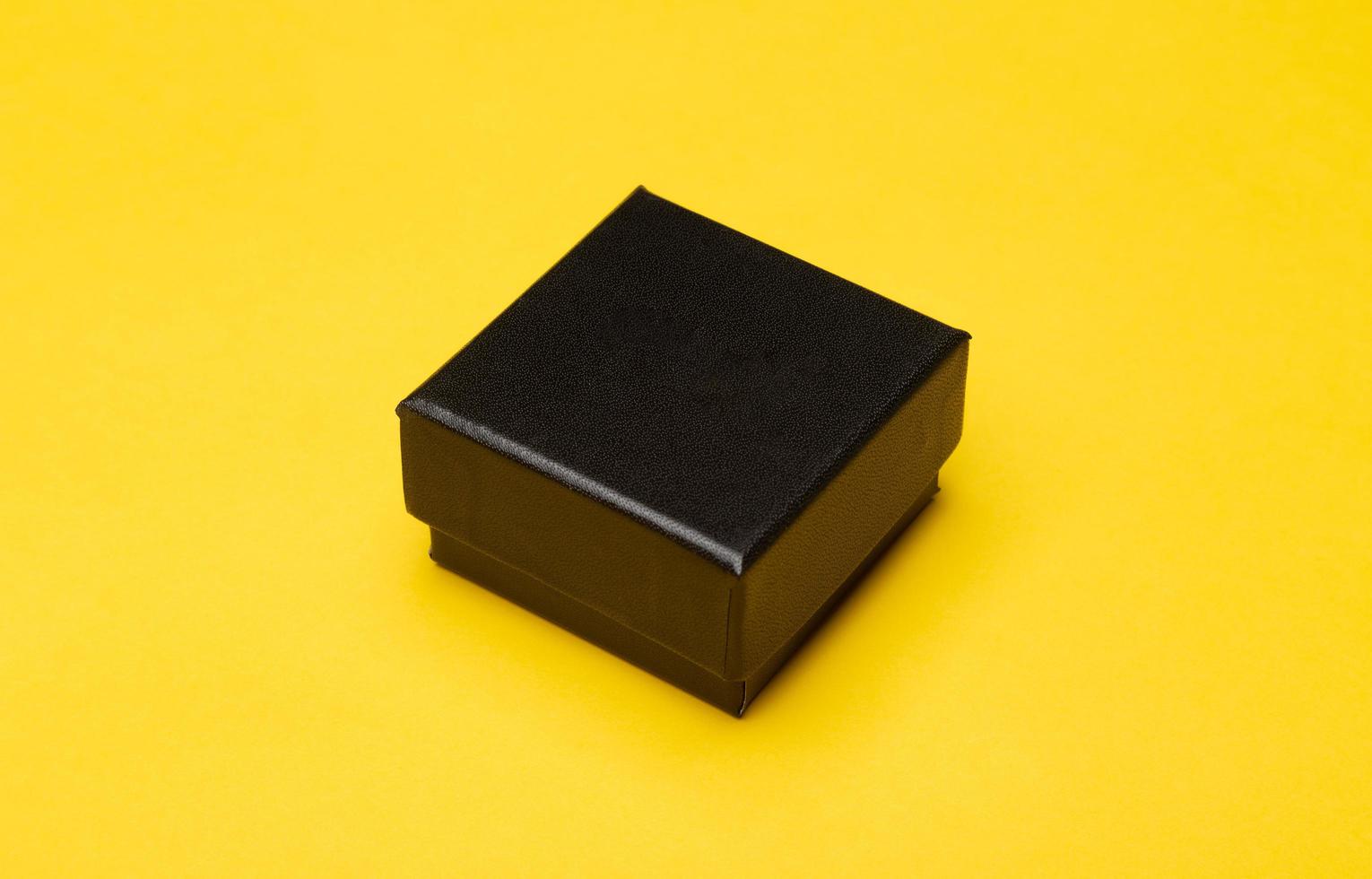 Black box packaging on yellow background photo