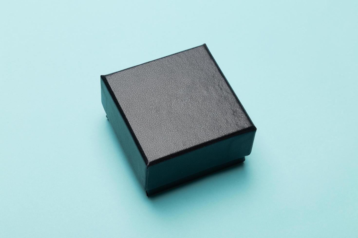 Black box packaging on blue background photo