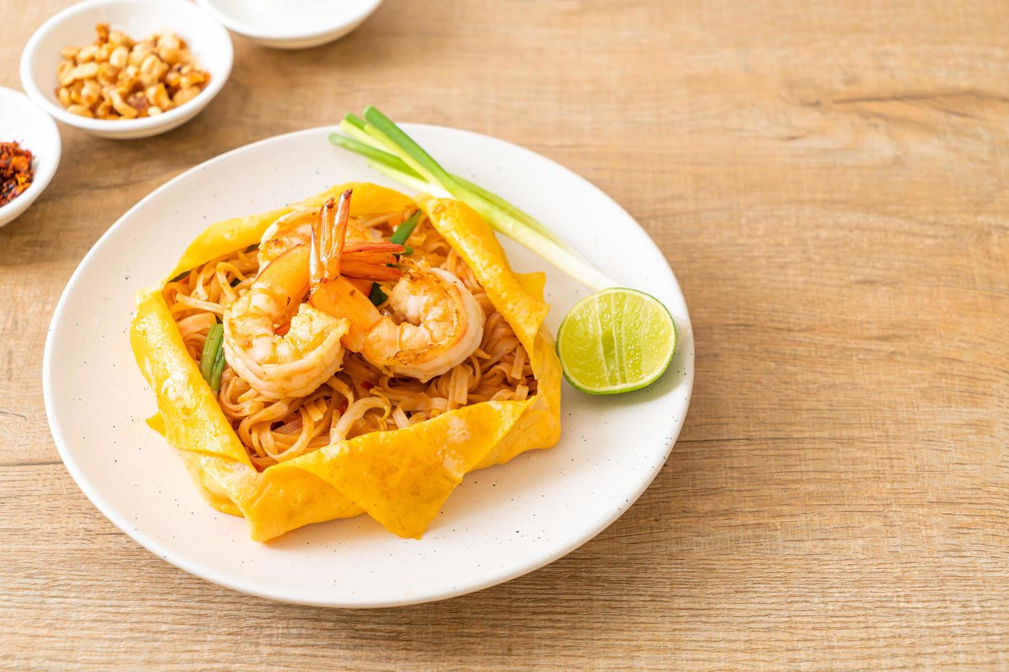 Thai stir fried noodles with shrimps and egg wrap or Pad Thai photo