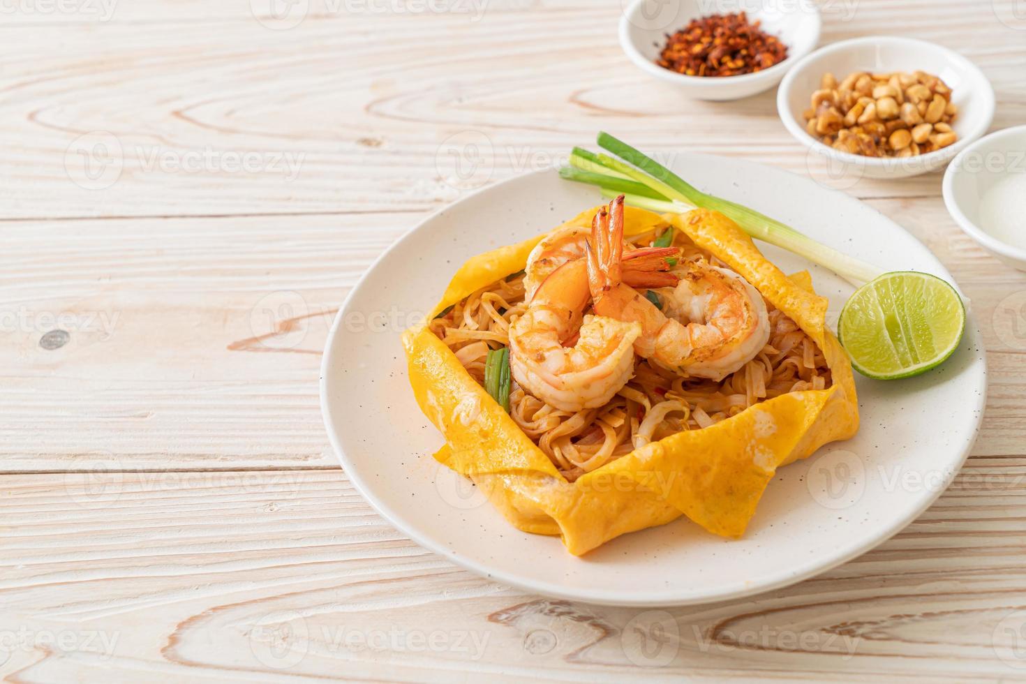 Thai stir fried noodles with shrimps and egg wrap or Pad Thai photo