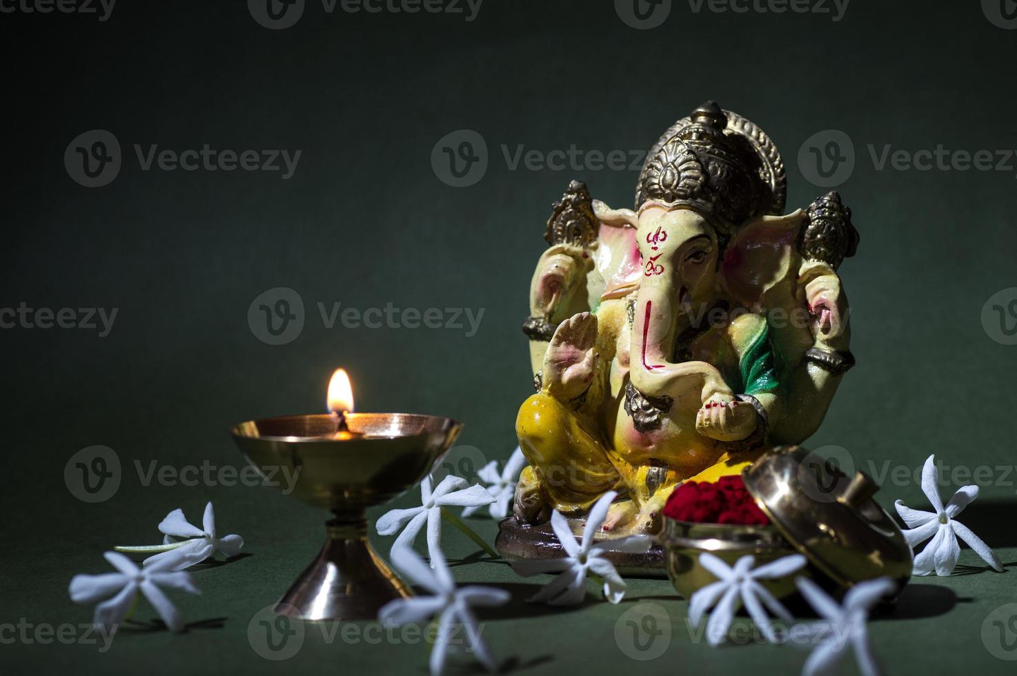 Hindu God Ganesha. Ganesha Idol. A colorful statue of Ganesha Idol on dark background. space for text or headline. photo