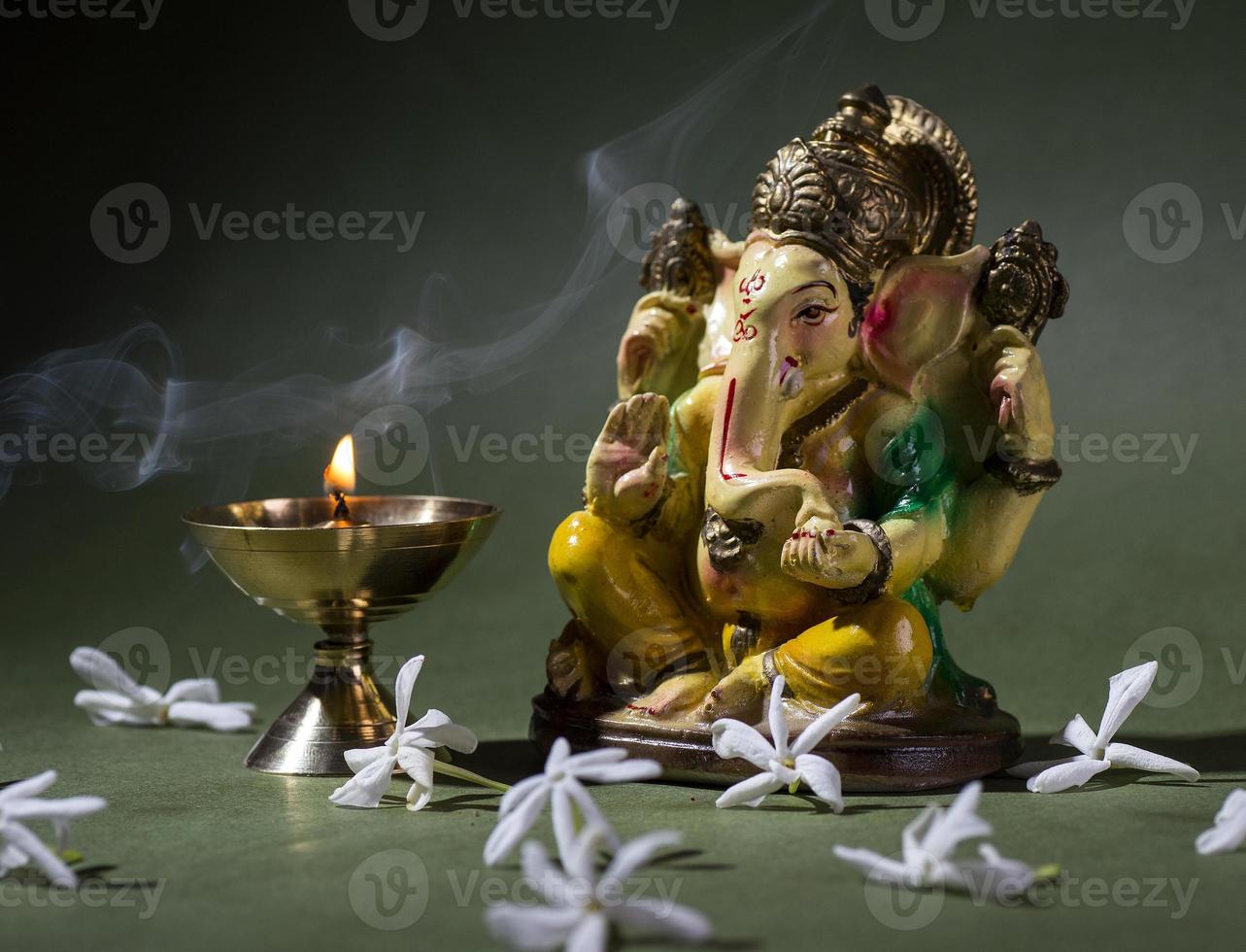 Hindu God Ganesha. Ganesha Idol. A colorful statue of Ganesha Idol on dark background. space for text or headline. photo