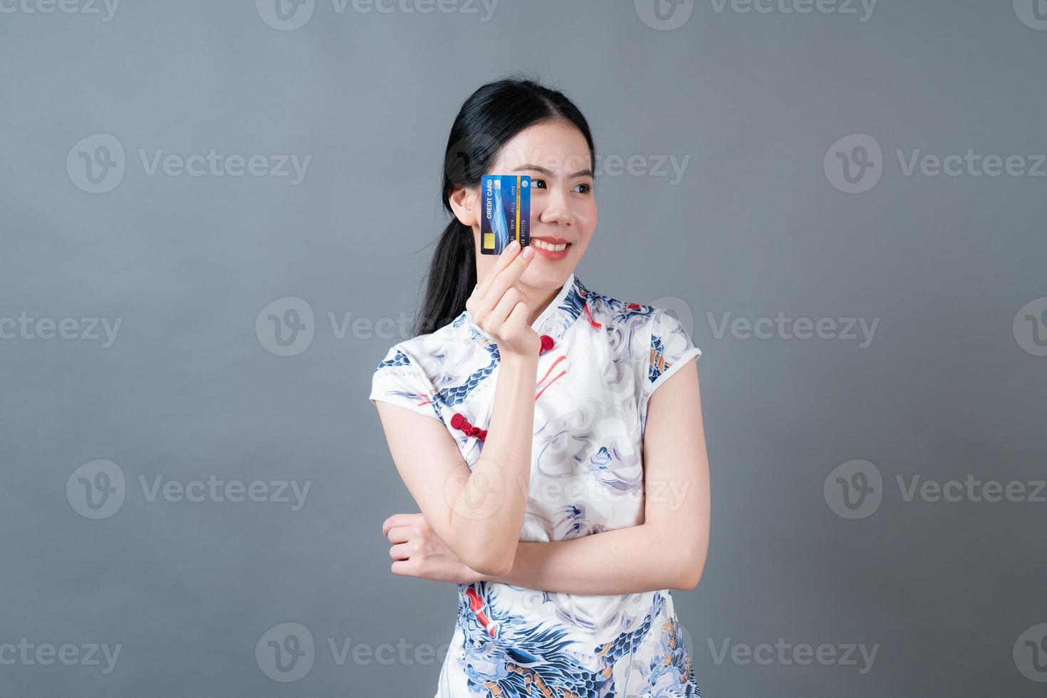 Asian woman wear Chinese traditional dress with hand holding credit card photo