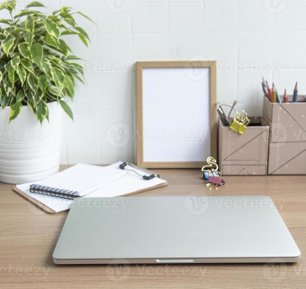 Laptop with office supplies on the table. photo