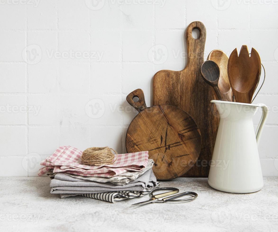 Kitchen utensils, tools and dishware on on the background white tile wall. photo