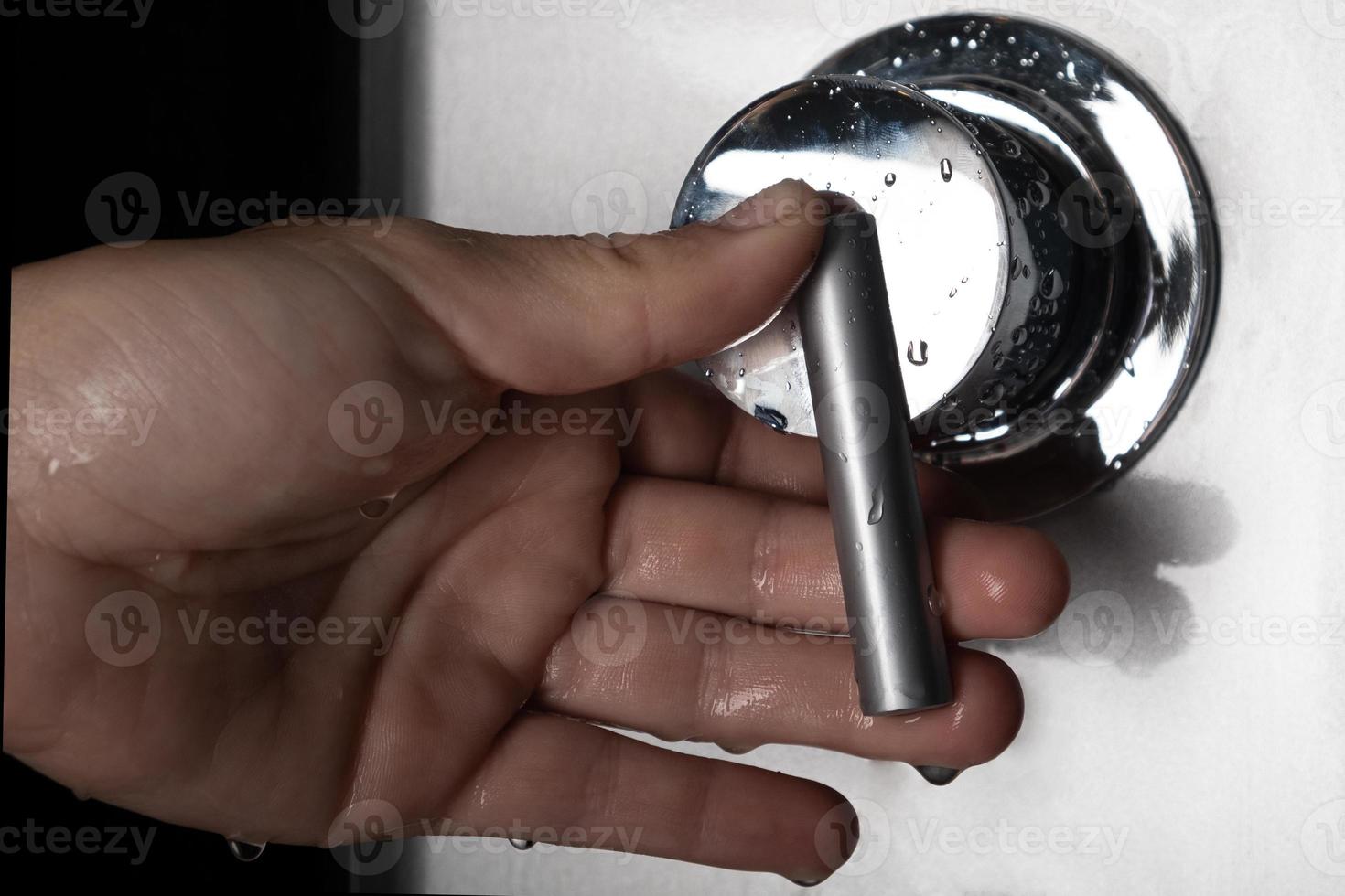 hand switches shower mixer for switching between hot and cold water photo