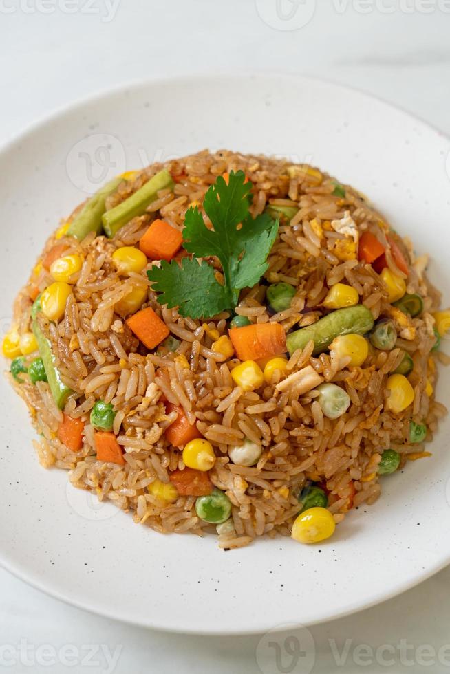 arroz frito con guisantes, zanahorias y maíz - estilo de comida vegetariana y saludable foto