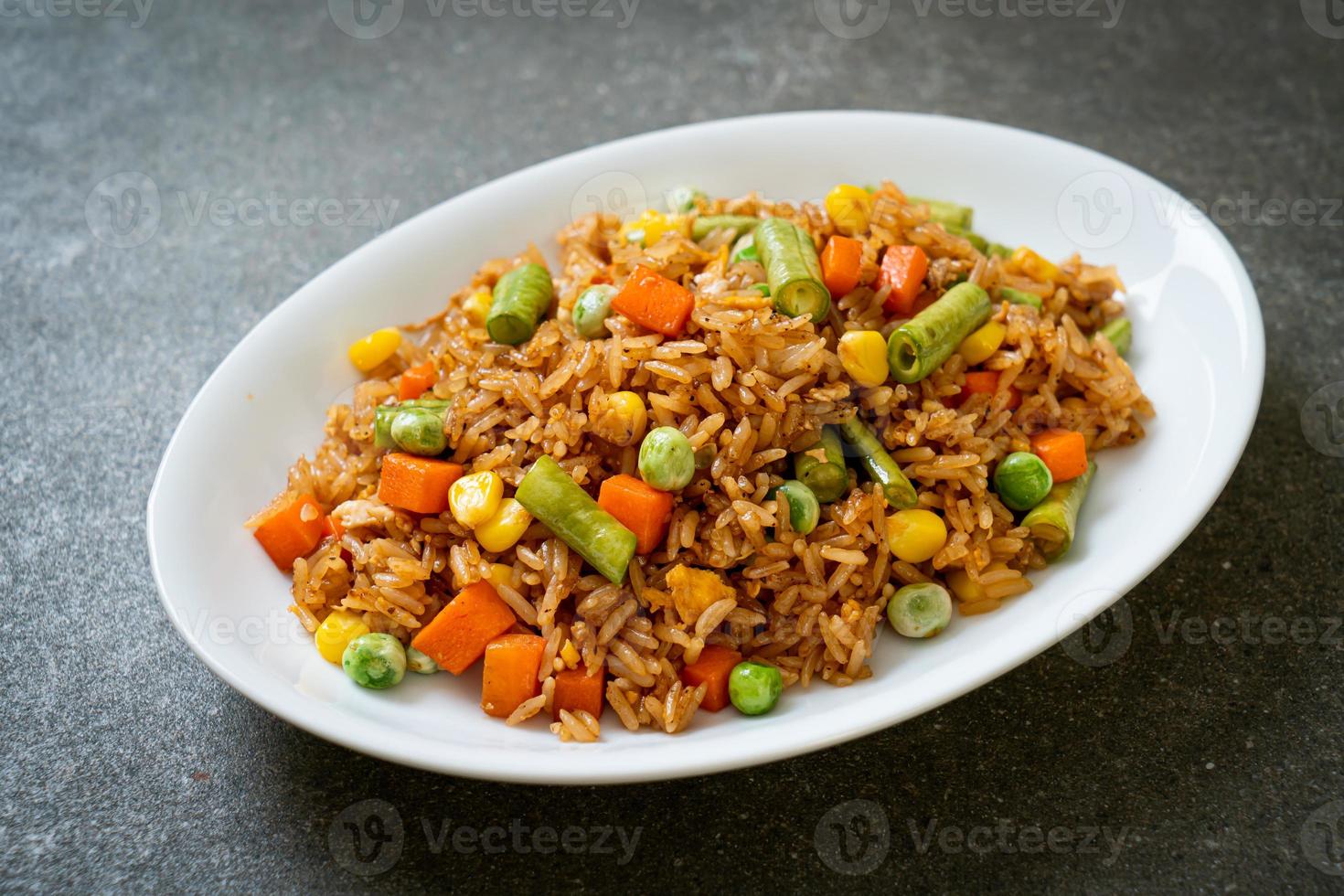 arroz frito con guisantes, zanahorias y maíz - estilo de comida vegetariana y saludable foto