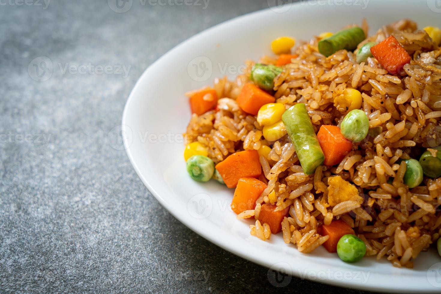 Fried rice with green peas, carrots, and corn - vegetarian and healthy